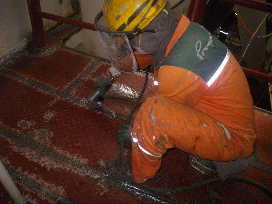 Operator preparing steel inside a ballast tank